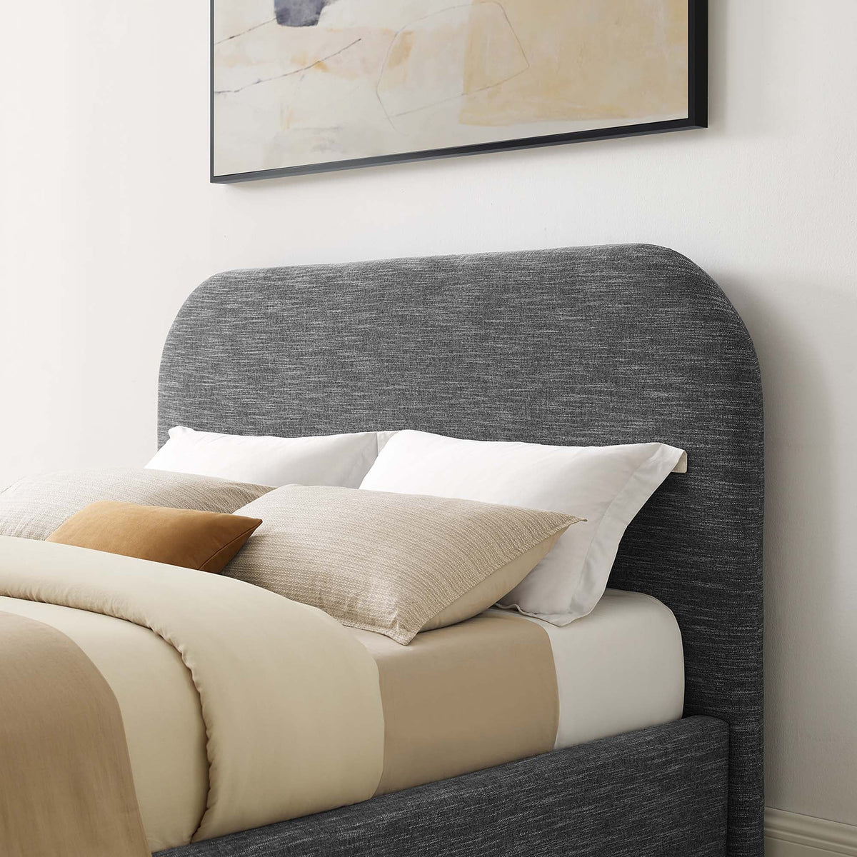 Keynote upholstered curved queen platform bed with dark gray headboard and beige bedding on Tampa Home & Garden Store