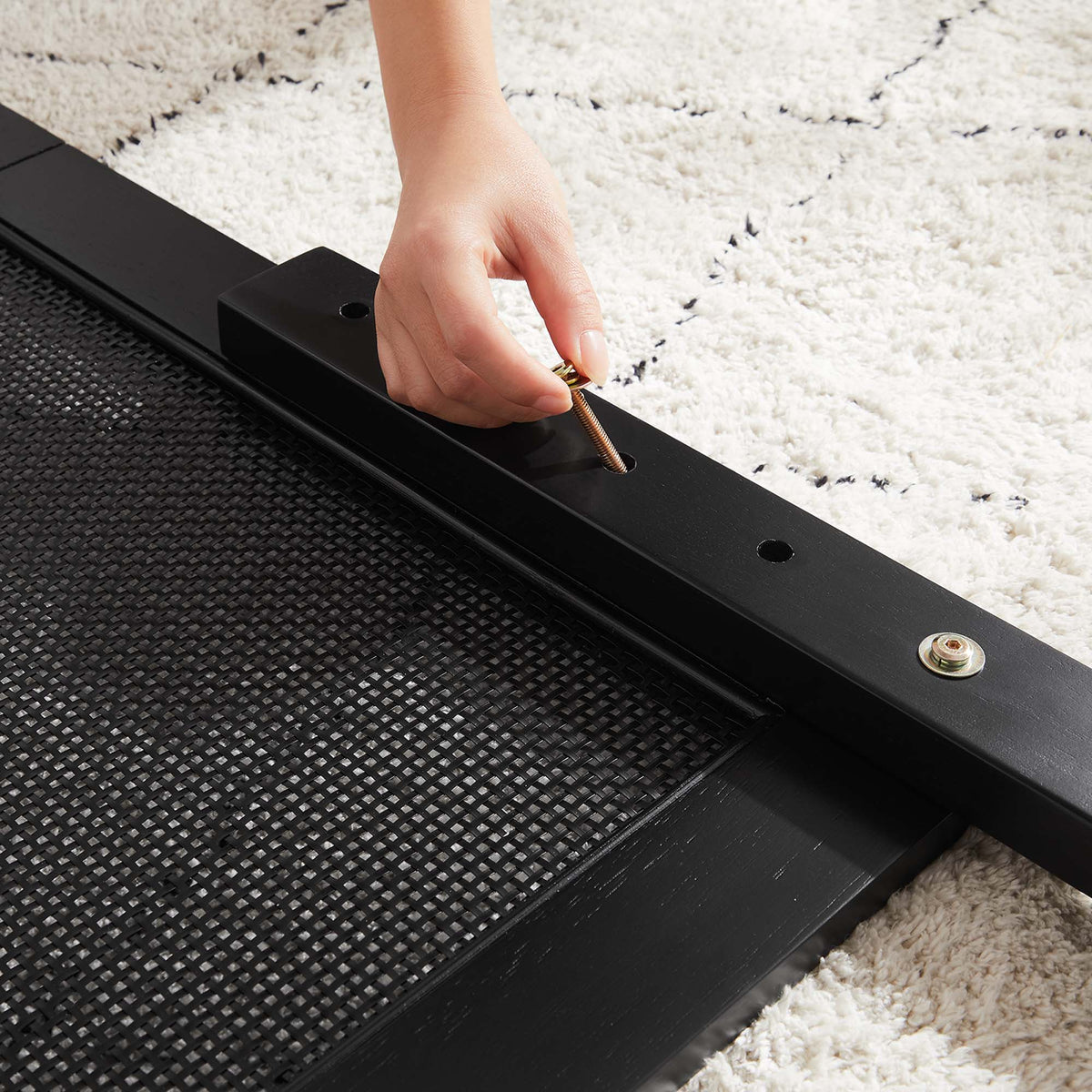 Sirocco rattan and wood platform bed frame in black with woven surface, tightening bolt on Tampa Home & Garden Store