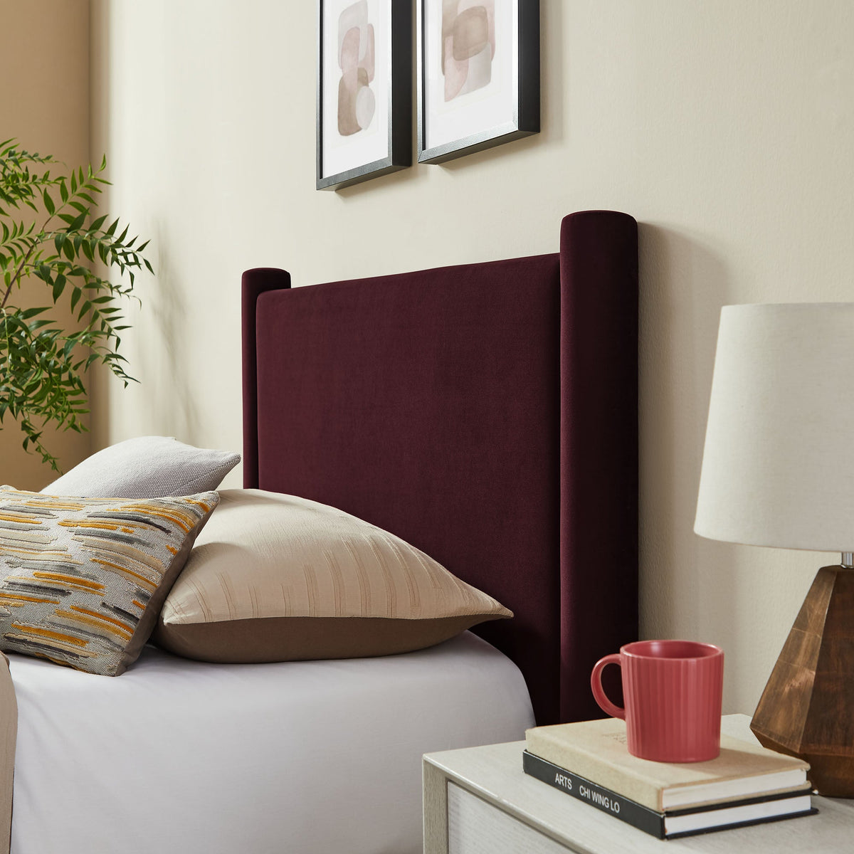 Rael rounded-post performance velvet platform bed in burgundy with bedding and plant on Tampa Home & Garden Store