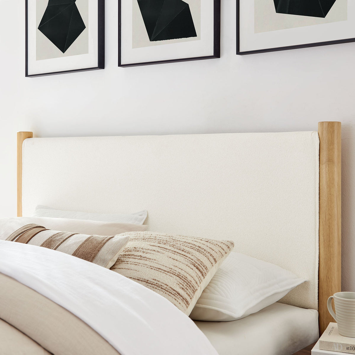 Maven Boucle Upholstered Platform Bed with beige fabric and wood posts in a calm bedroom on Tampa Home & Garden Store