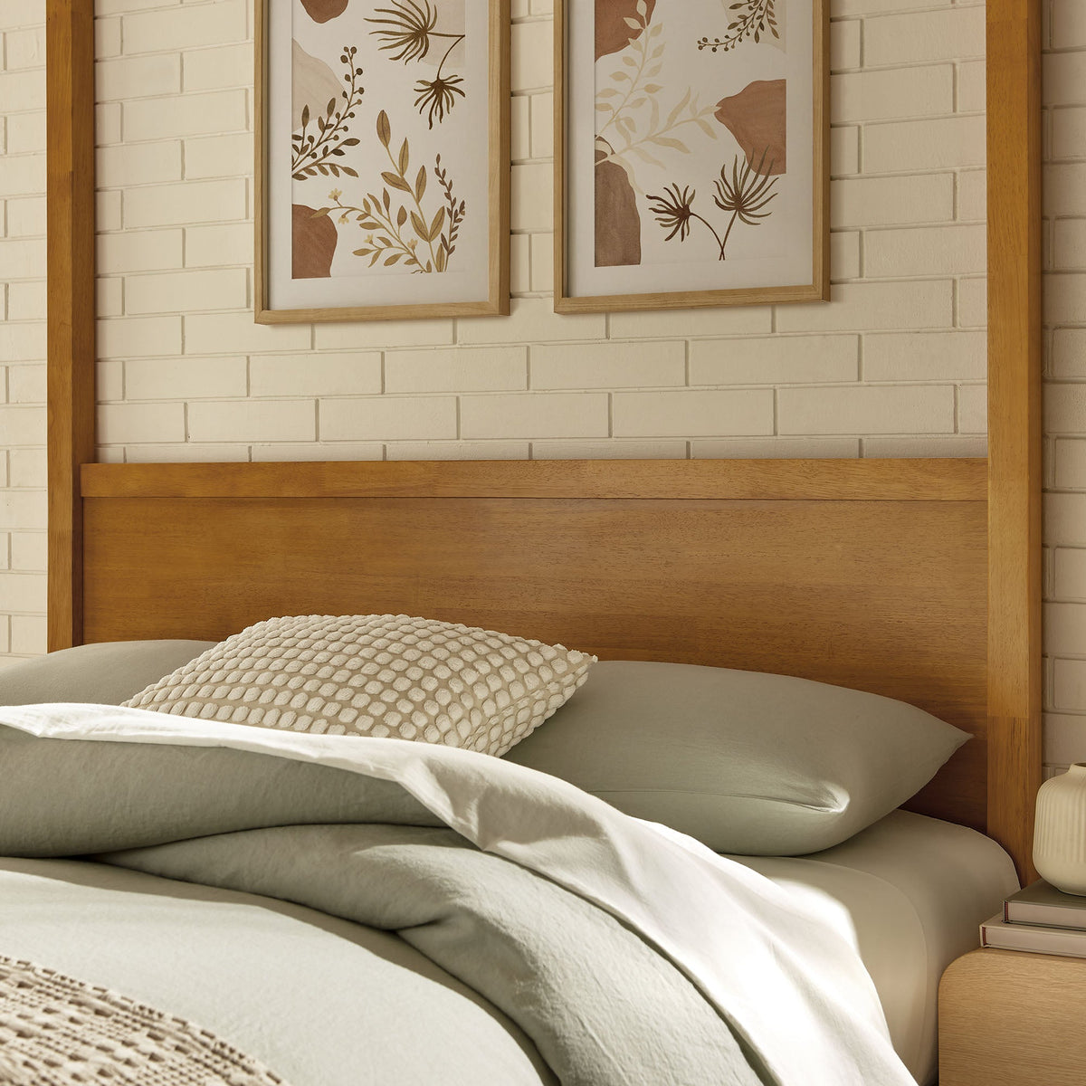Alva King wood canopy platform bed in natural oak finish with 2 botanical prints on wall on Tampa Home & Garden Store