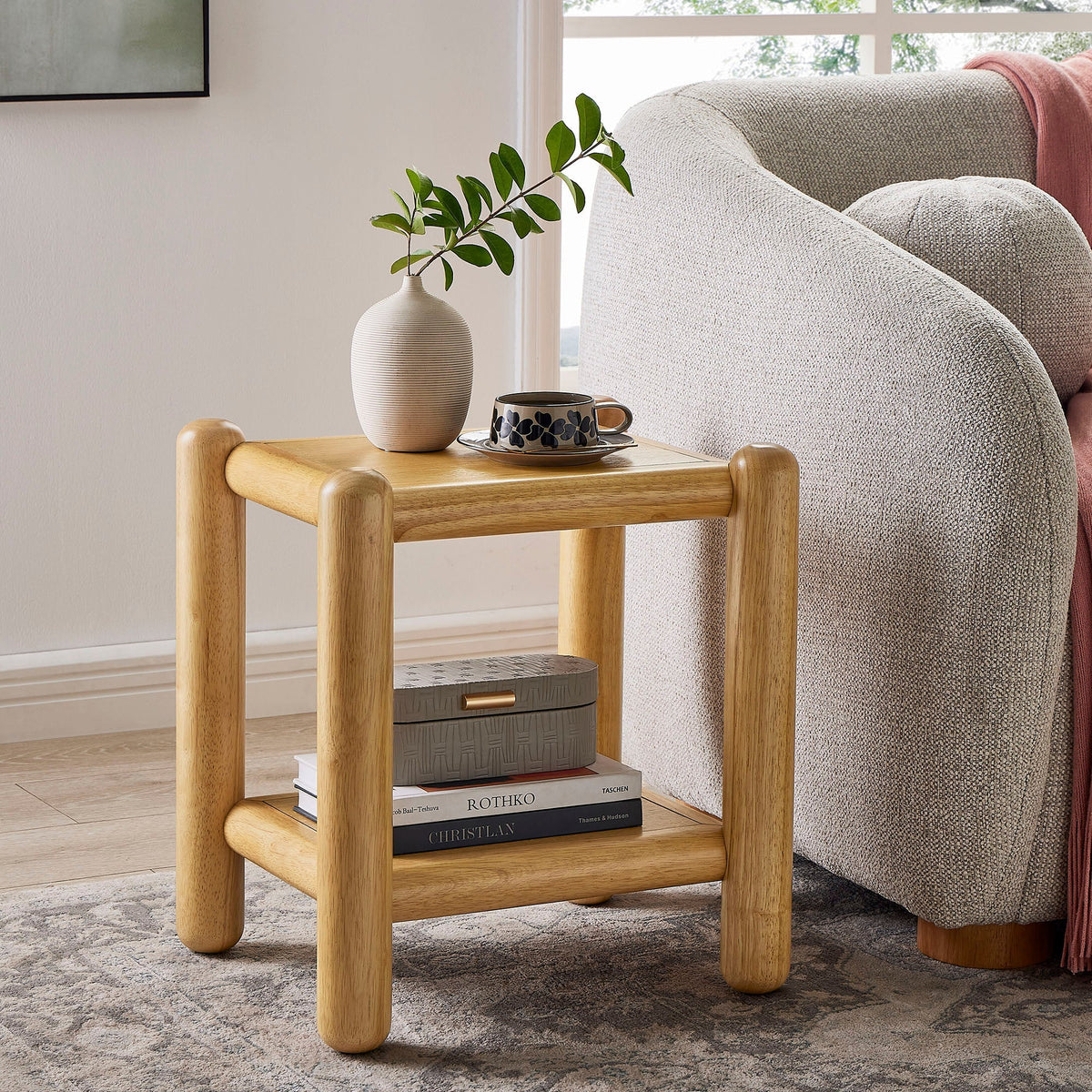 Arcus 2-Tier Side Table in natural wood with rounded legs; vase on top, boxes below shelf on Tampa Home & Garden Store