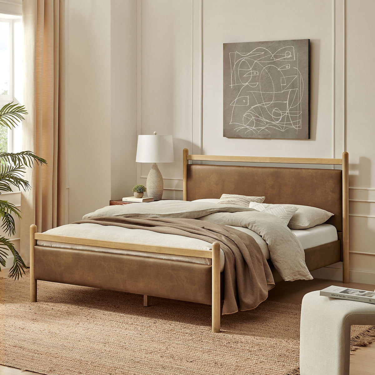 Ginny vegan leather platform bed frame with tan upholstered headboard and matching bed skirt on Tampa Home & Garden Store