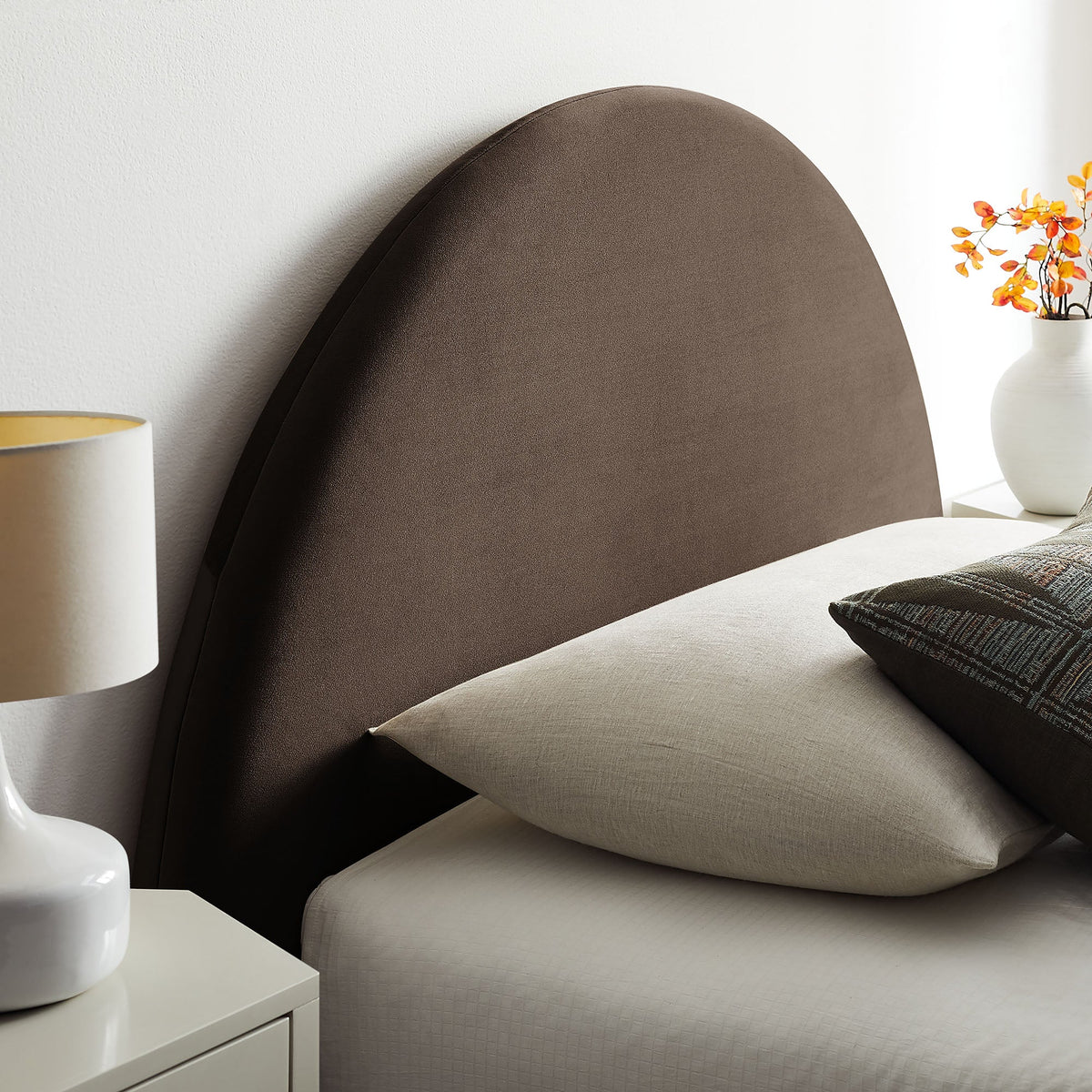 Resort arched velvet storage platform bed frame in brown with beige bed skirt and nightstand on Tampa Home & Garden Store