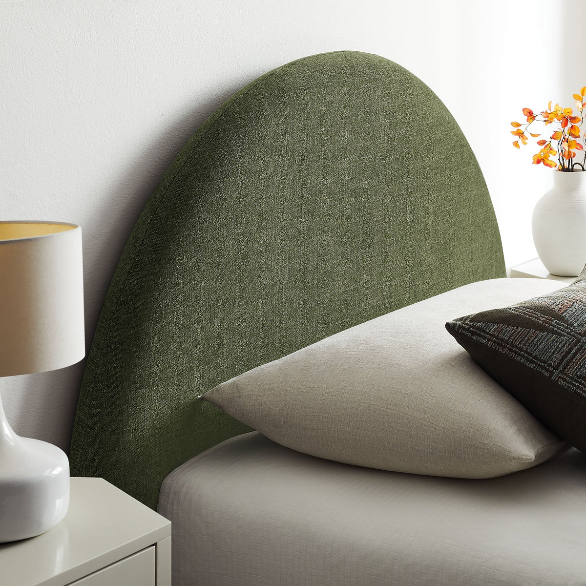 Resort arched upholstered fabric storage bed frame in olive green with beige bedding on Tampa Home & Garden Store