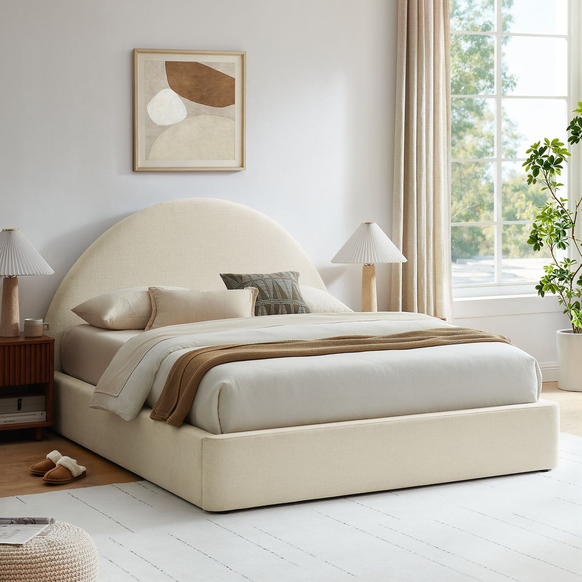 Resort arched upholstered fabric storage platform bed frame in cream with beige bedding on Tampa Home & Garden Store