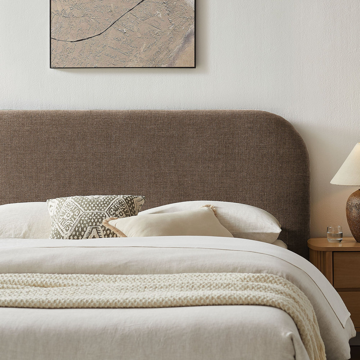 Keynote fabric upholstered storage platform bed frame with brown headboard and white bedding on Tampa Home & Garden Store