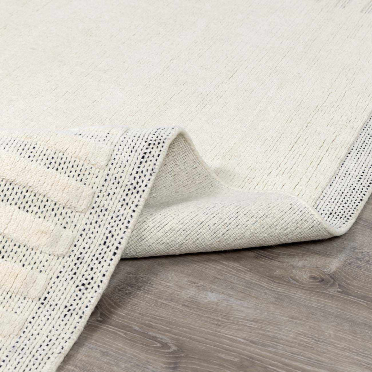 Yulia Wool Area Rug by Boutique Rugs, cream ivory with subtle texture and dotted border on Tampa Home & Garden Store