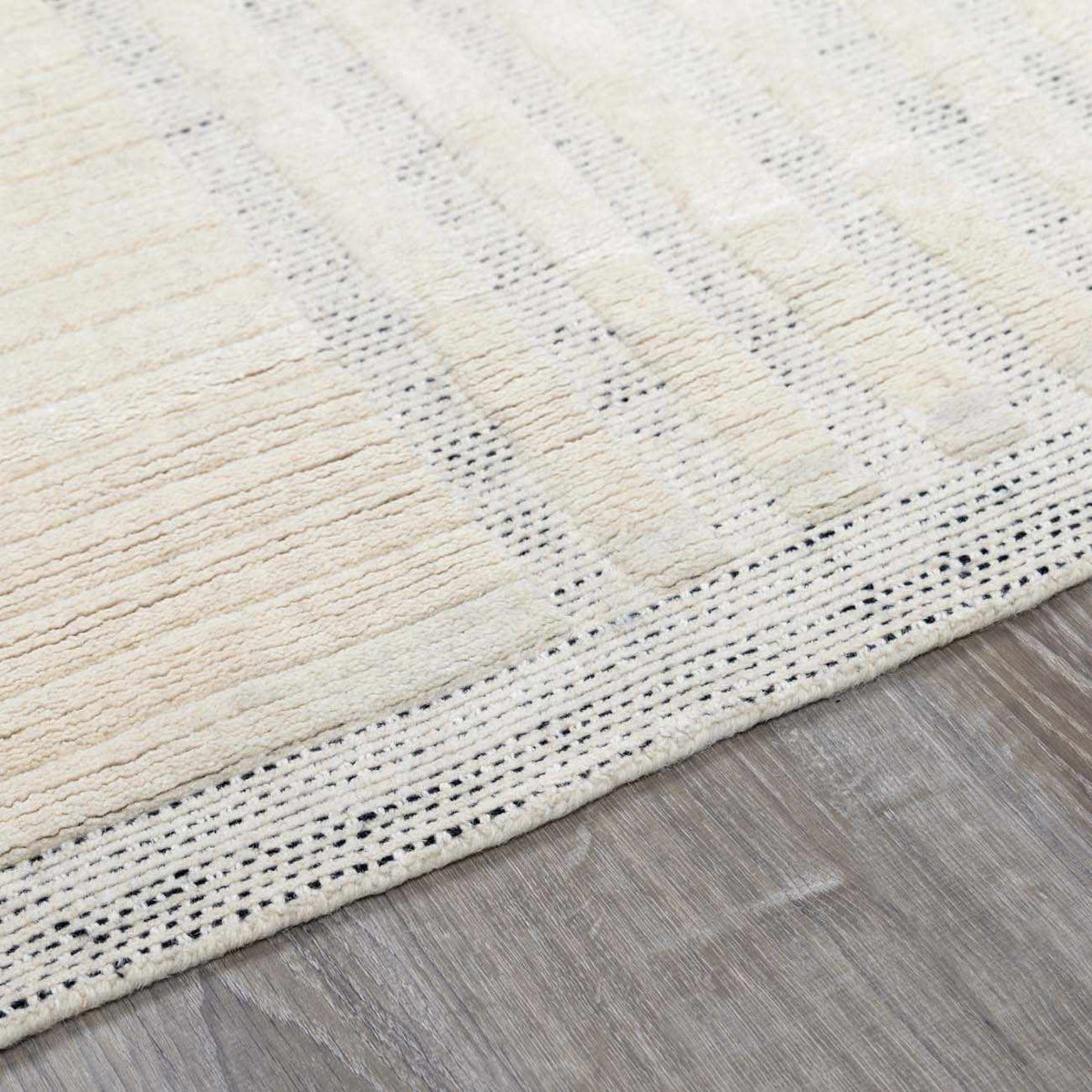 Yulia Wool Area Rug by Boutique Rugs, cream with subtle tan stripes and dotted border on Tampa Home & Garden Store