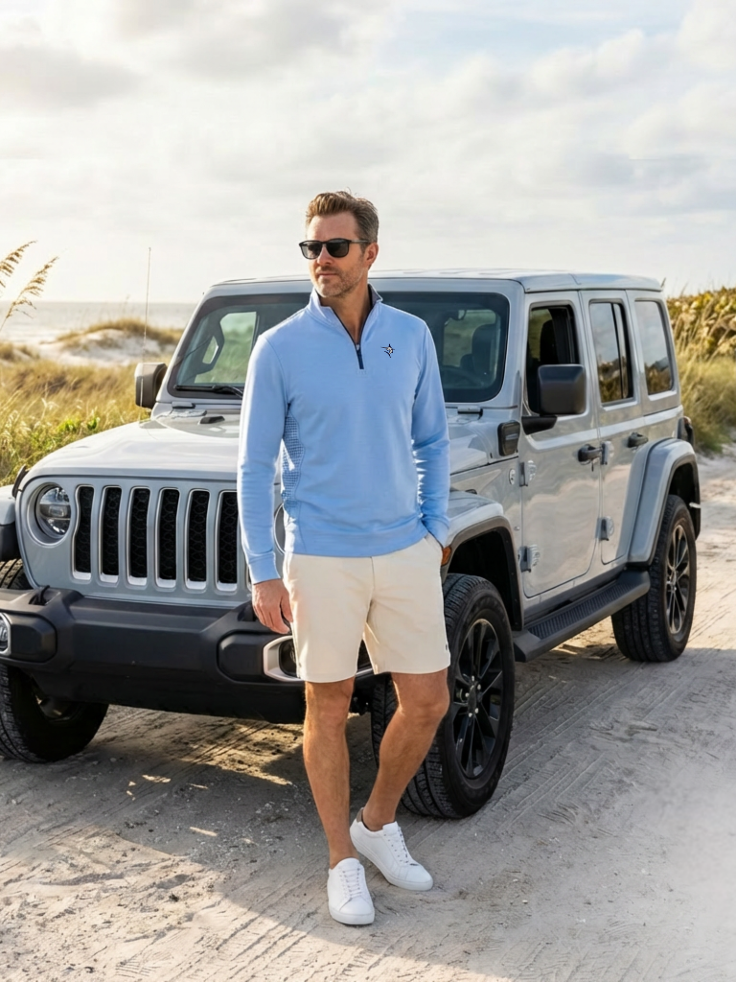 Freeport Short by White Water Life in beige khaki worn by a man beside a silver Jeep on a beach on Tampa Home & Garden Store