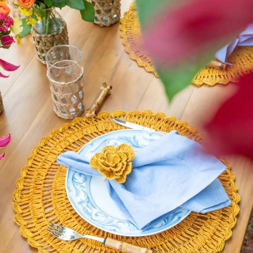 Buriti straw placemats by Talah Home, handcrafted circular woven placemats in golden yellow on Tampa Home & Garden Store
