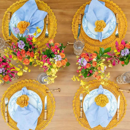 Buriti straw placemats by Talah Home, handcrafted set of four with yellow rims and blue napkins on Tampa Home & Garden Store