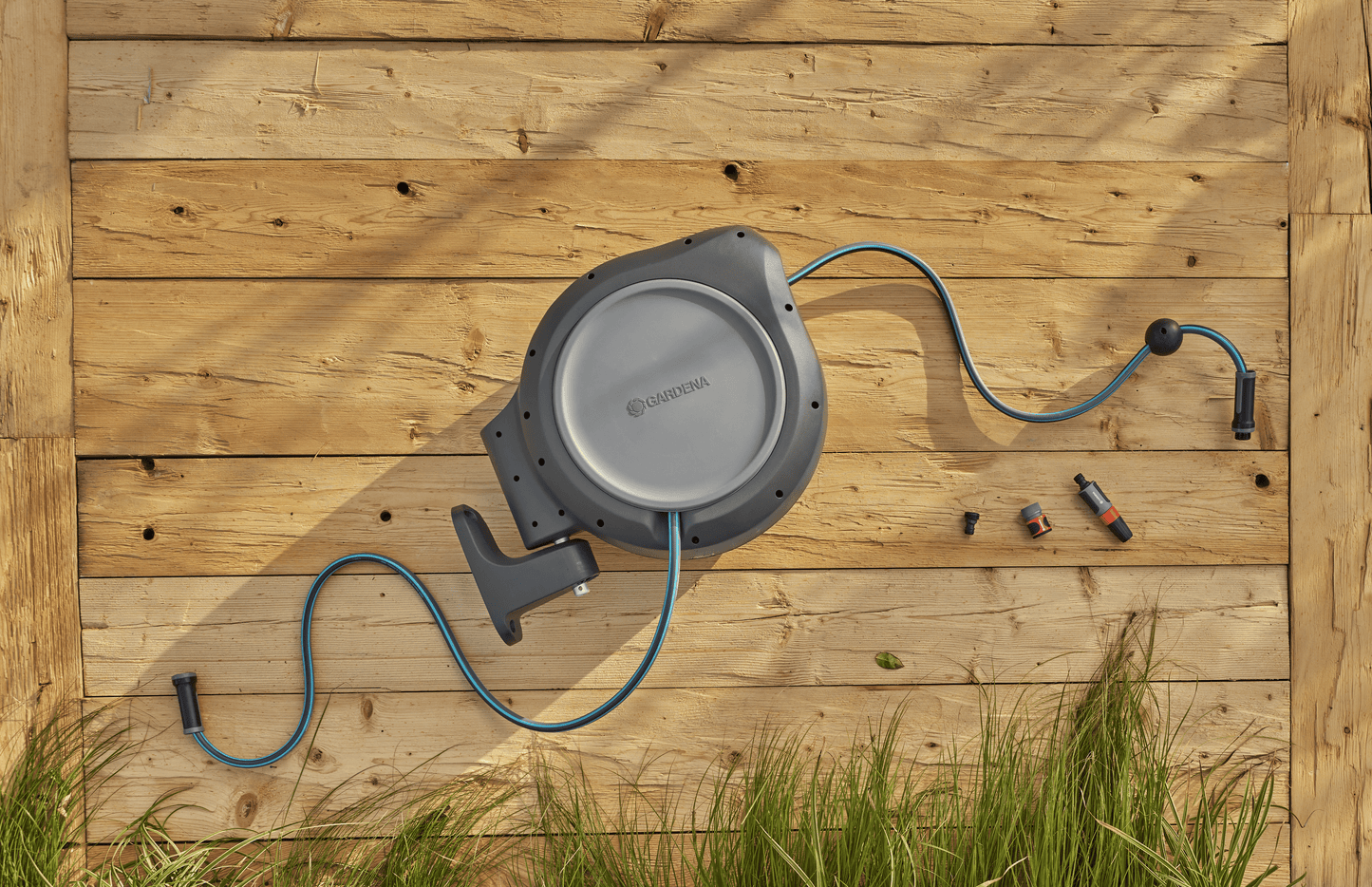 Gardena 50 ft retractable hose reel with blue hose and gray housing on a wooden deck on Tampa Home & Garden Store