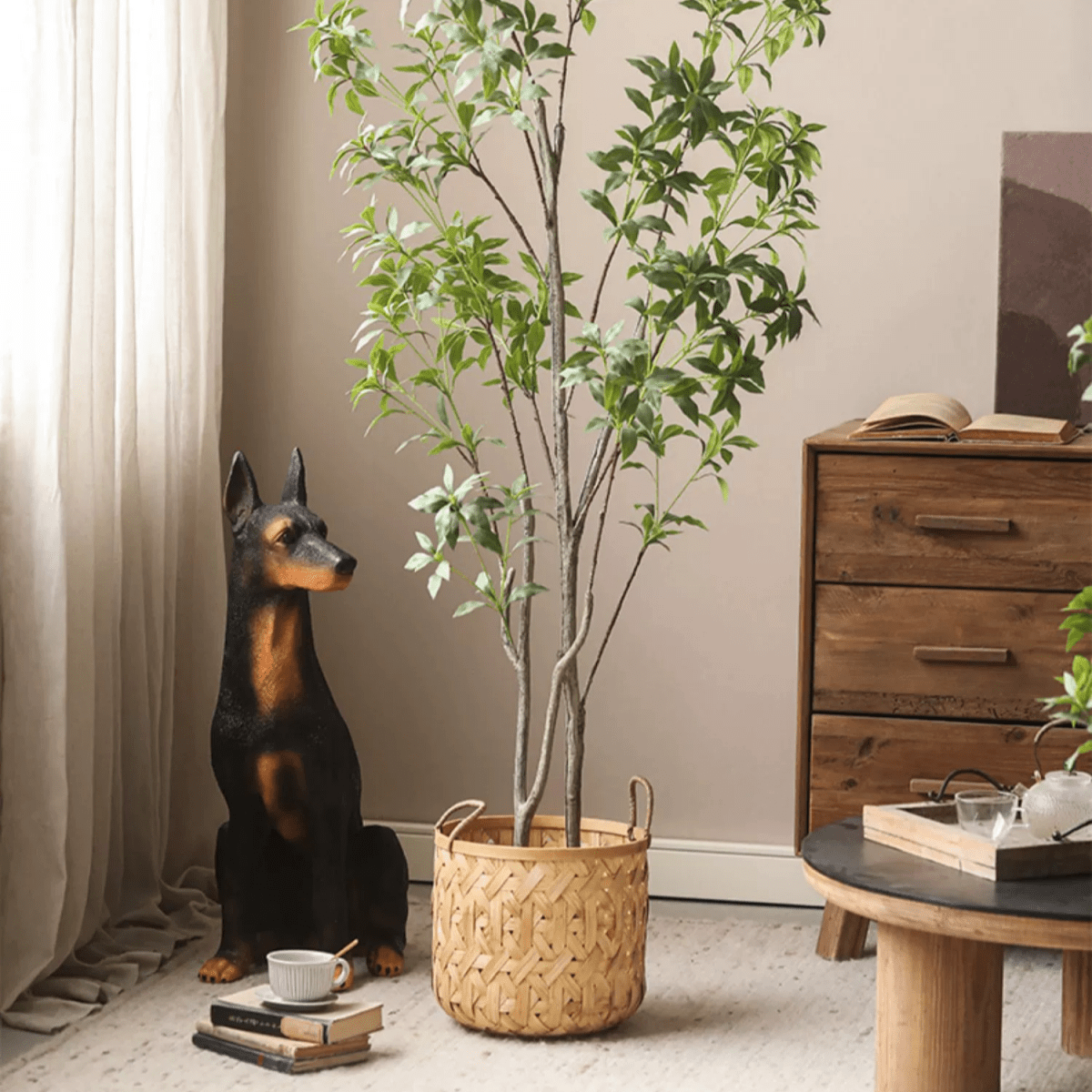 Bamboo Woven Storage Basket with handles holding a tall indoor plant on Tampa Home & Garden Store