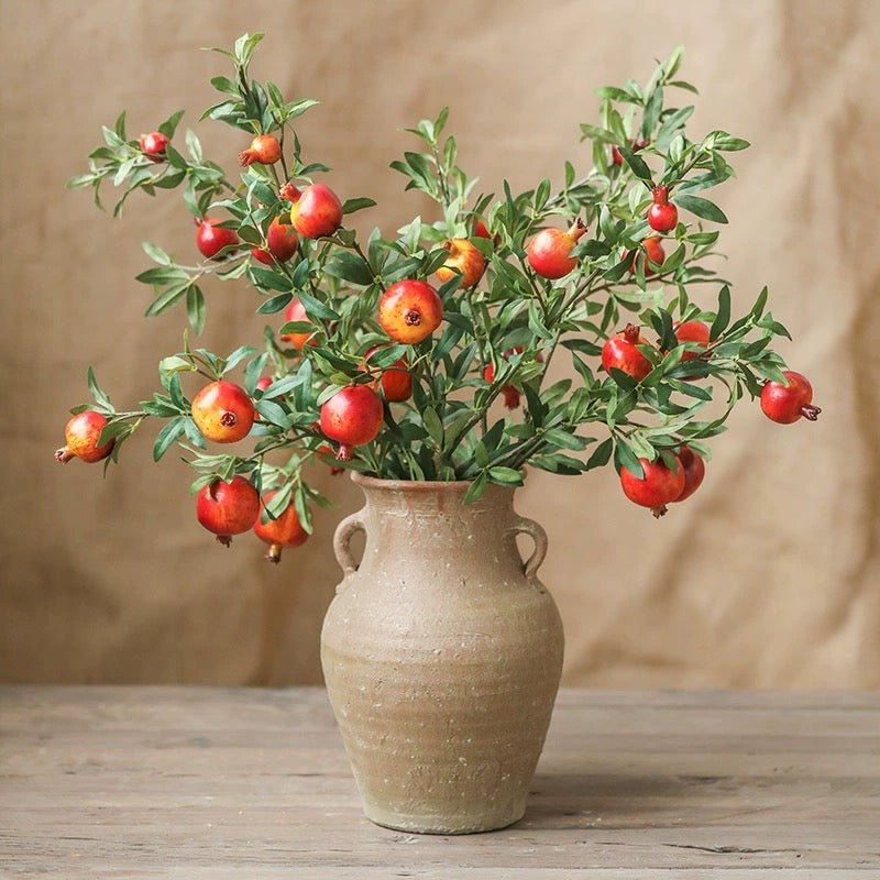Big Fruit Faux Pomegranate Stem 32in Tall by RusticReach with green leaves in a beige vase on Tampa Home & Garden Store