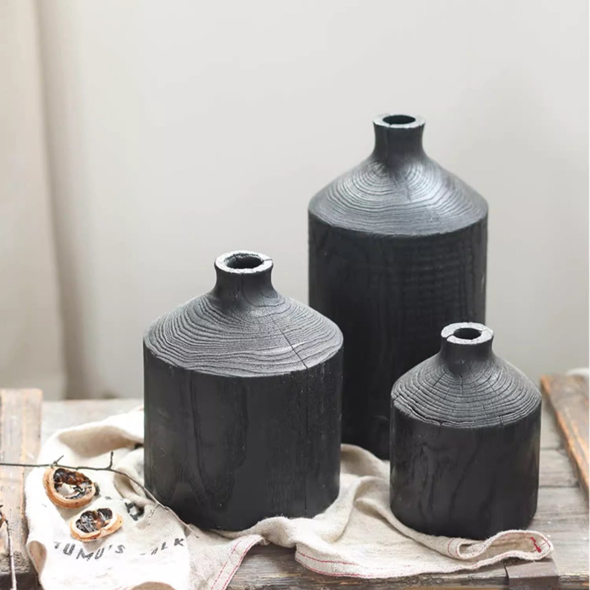 Black wooden vases with narrow necks in three heights by RusticReach on a wood surface on Tampa Home & Garden Store