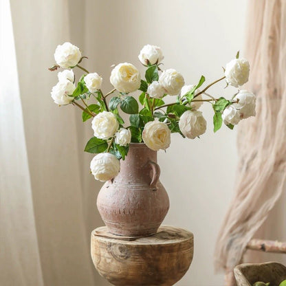 White Cabbage Rose Stem bouquet in a pink ceramic vase on a rustic wood pedestal on Tampa Home & Garden Store