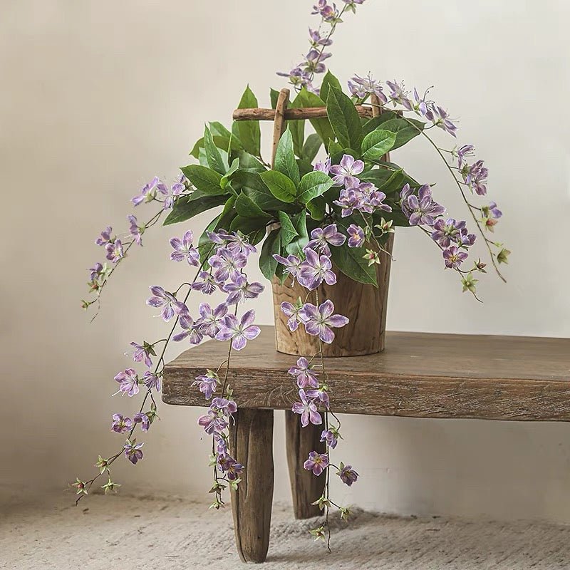 Artificial Cytha Jasmin Stem with cascading purple blooms and green leaves in wooden pot on Tampa Home & Garden Store