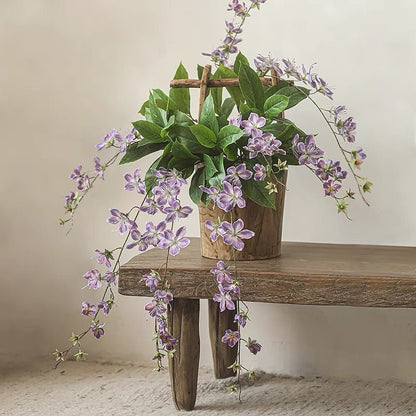 Artificial Cytha Jasmin Stem with cascading purple blooms and green leaves in wooden pot on Tampa Home & Garden Store