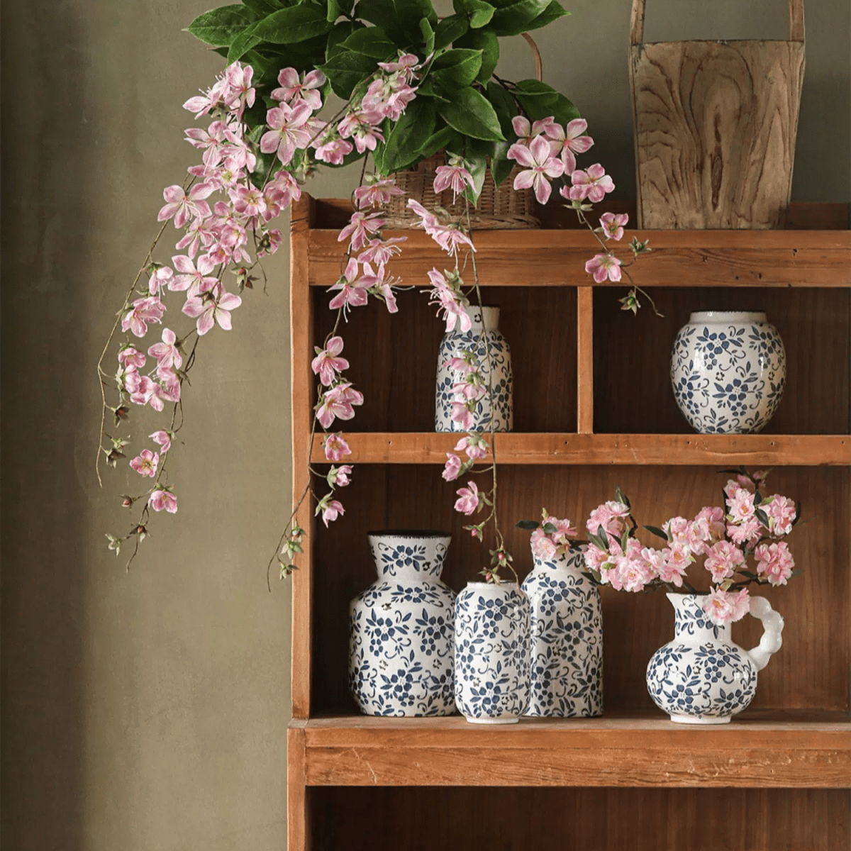 Artificial Cytha Jasmin Stem RusticReach pink cascading blooms over blue vases on shelf on Tampa Home & Garden Store