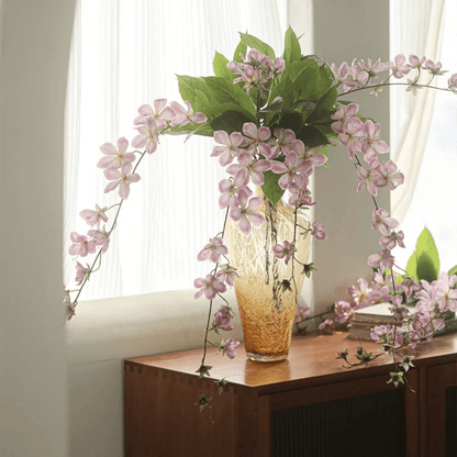 Artificial Cytha Jasmine stem with pink blooms in amber vase and green leaves RusticReach on Tampa Home & Garden Store