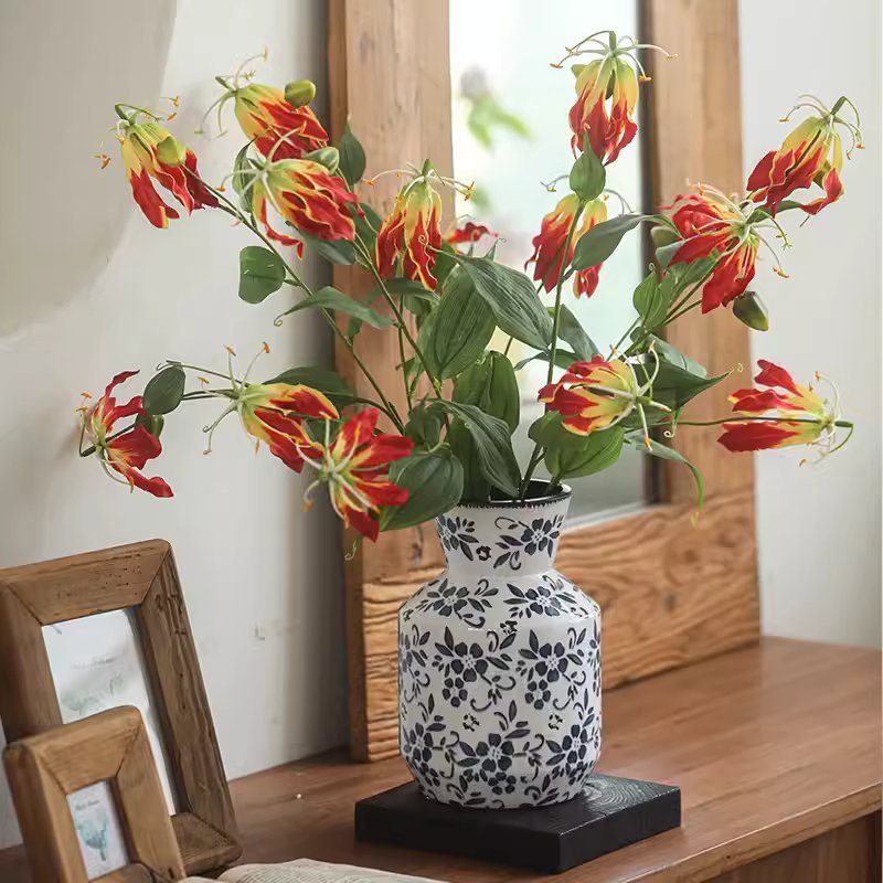 Faux Fire Lily Stem by RusticReach in ceramic vase with blue floral pattern on a wooden table on Tampa Home & Garden Store