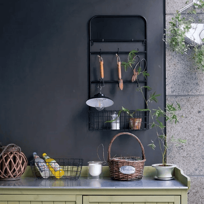 Industrial garden tool storage rack by RusticReach, black steel wall-mount with hooks on Tampa Home & Garden Store