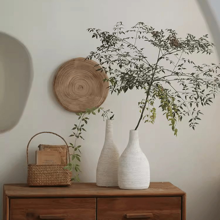 Narrow-neck white ribbed ceramic vases, RusticReach, with greenery on a wooden dresser on Tampa Home & Garden Store
