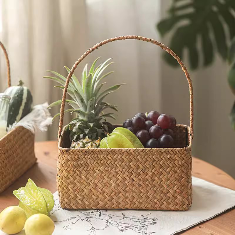 Rectangular woven basket organizer straw color with handle, filled with pineapple & grapes on Tampa Home & Garden Store