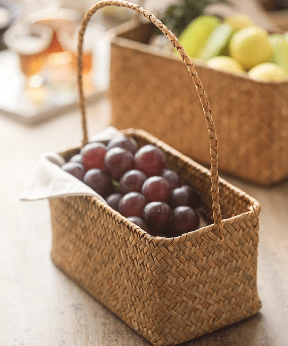 Rectangular Woven Carry Basket Organizer by RusticReach natural fiber filled with plums on Tampa Home & Garden Store