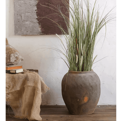 Round earthenware brown pot with ribbed texture by RusticReach filled with tall grasses on Tampa Home & Garden Store
