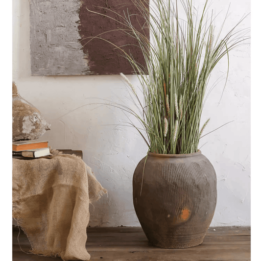 Round earthenware brown pot with ribbed texture by RusticReach filled with tall grasses on Tampa Home & Garden Store