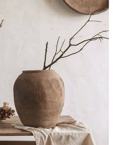 Round Earthenware Brown Pot by RusticReach with ribbed texture on wooden table holding branches on Tampa Home & Garden Store