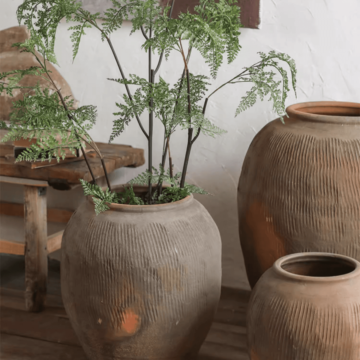 Round Earthenware Brown Pot trio with ribbed texture by RusticReach, one holding greenery on Tampa Home & Garden Store