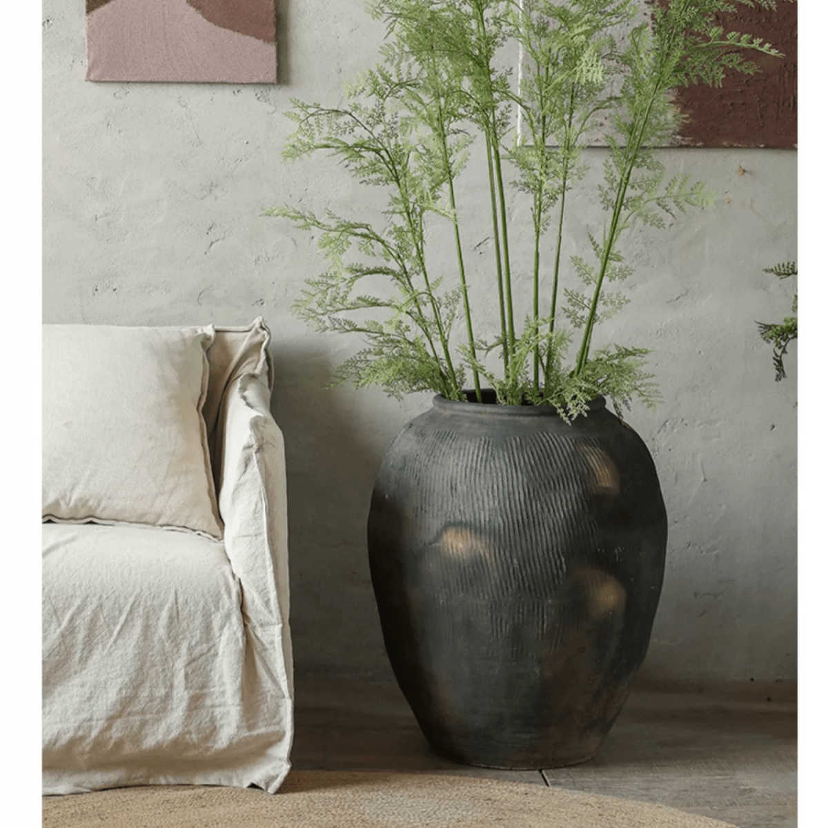 Round Earthenware Gray Pot by RusticReach with tall green ferns beside a beige sofa on Tampa Home & Garden Store
