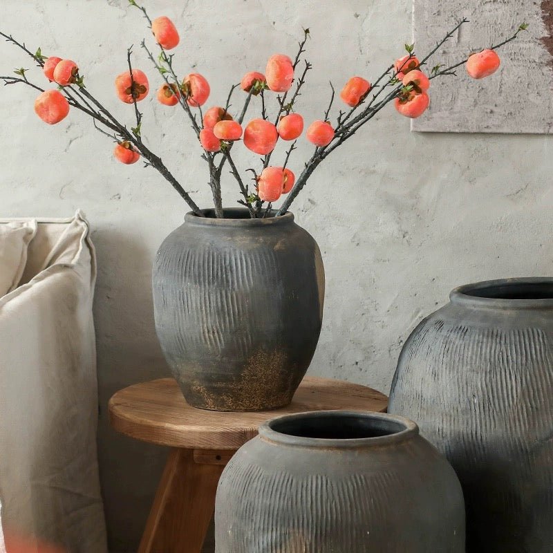 Round gray earthenware pot by RusticReach with peach branches; two pots on wooden table on Tampa Home & Garden Store