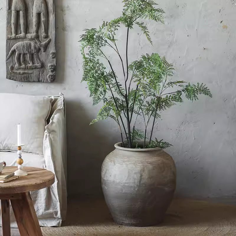 Round Earthenware Pot by RusticReach with weathered gray glaze housing a leafy fern on Tampa Home & Garden Store