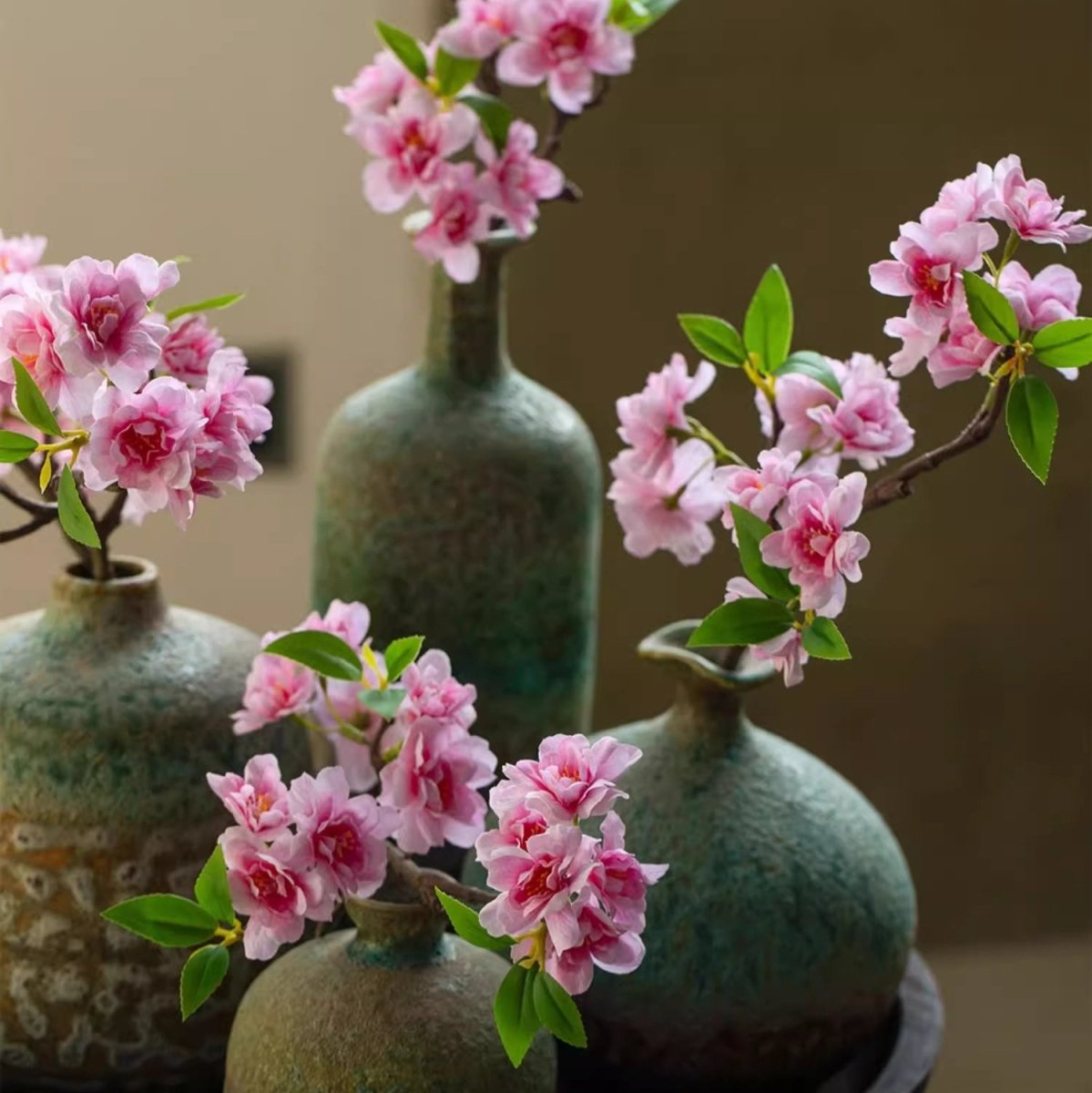 Peach blossom stem, 16.5 in tall, pink artificial blossoms with green leaves in rustic vases on Tampa Home & Garden Store