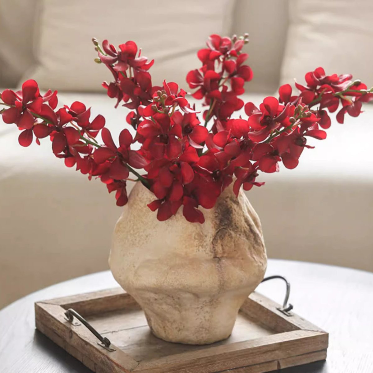 Single red orchid stem 24in tall in a rustic beige vase on a wooden tray on Tampa Home & Garden Store
