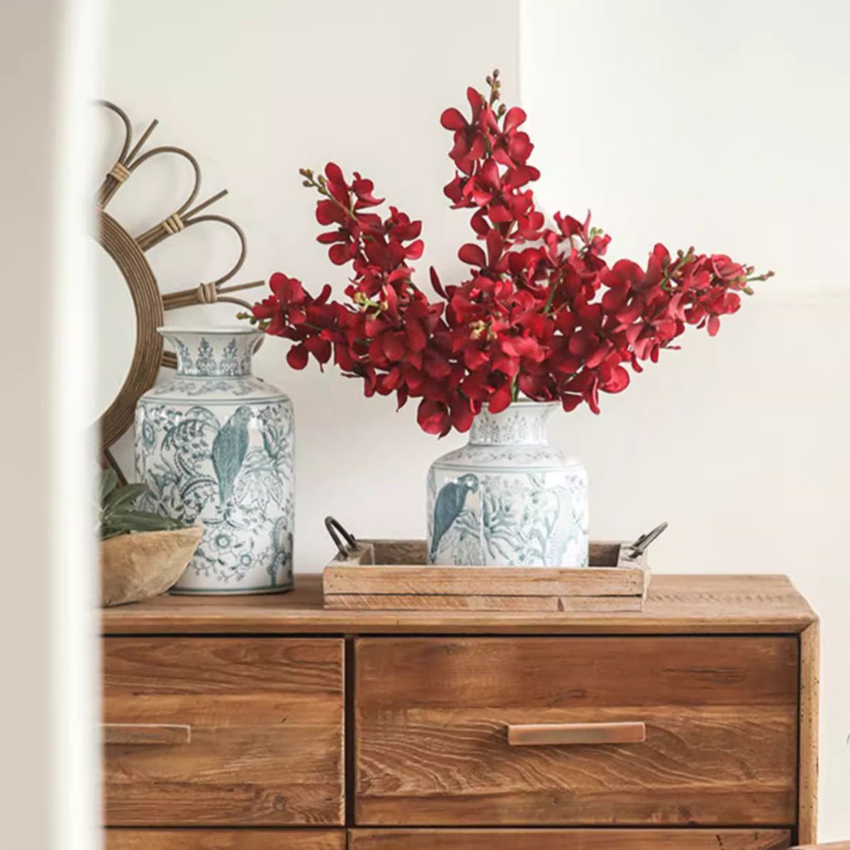 Single red orchid stem 24 inches tall in blue and white ceramic vase on wooden dresser RusticReach on Tampa Home & Garden Store