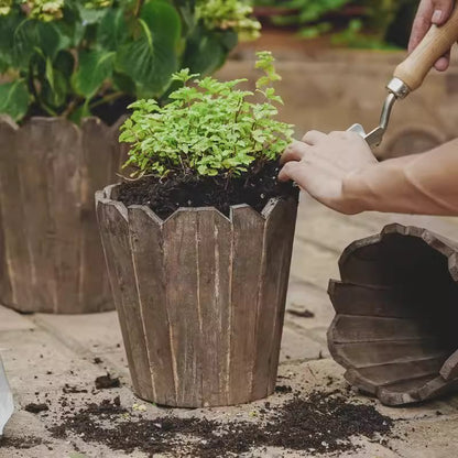 Round spliced solid wood planter by RusticReach with herb plant in soil on a garden table on Tampa Home & Garden Store