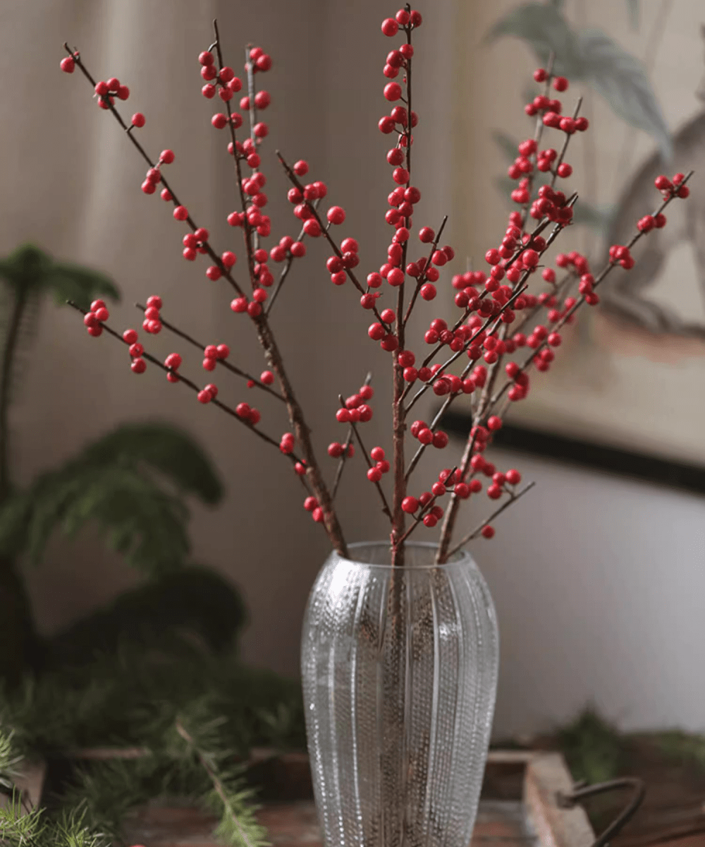 Faux Red Winterberry Stem with red berries on brown branches in a tall ribbed glass vase on Tampa Home & Garden Store