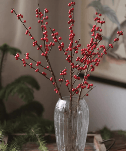 Faux Red Winterberry Stem with red berries on brown branches in a tall ribbed glass vase on Tampa Home & Garden Store