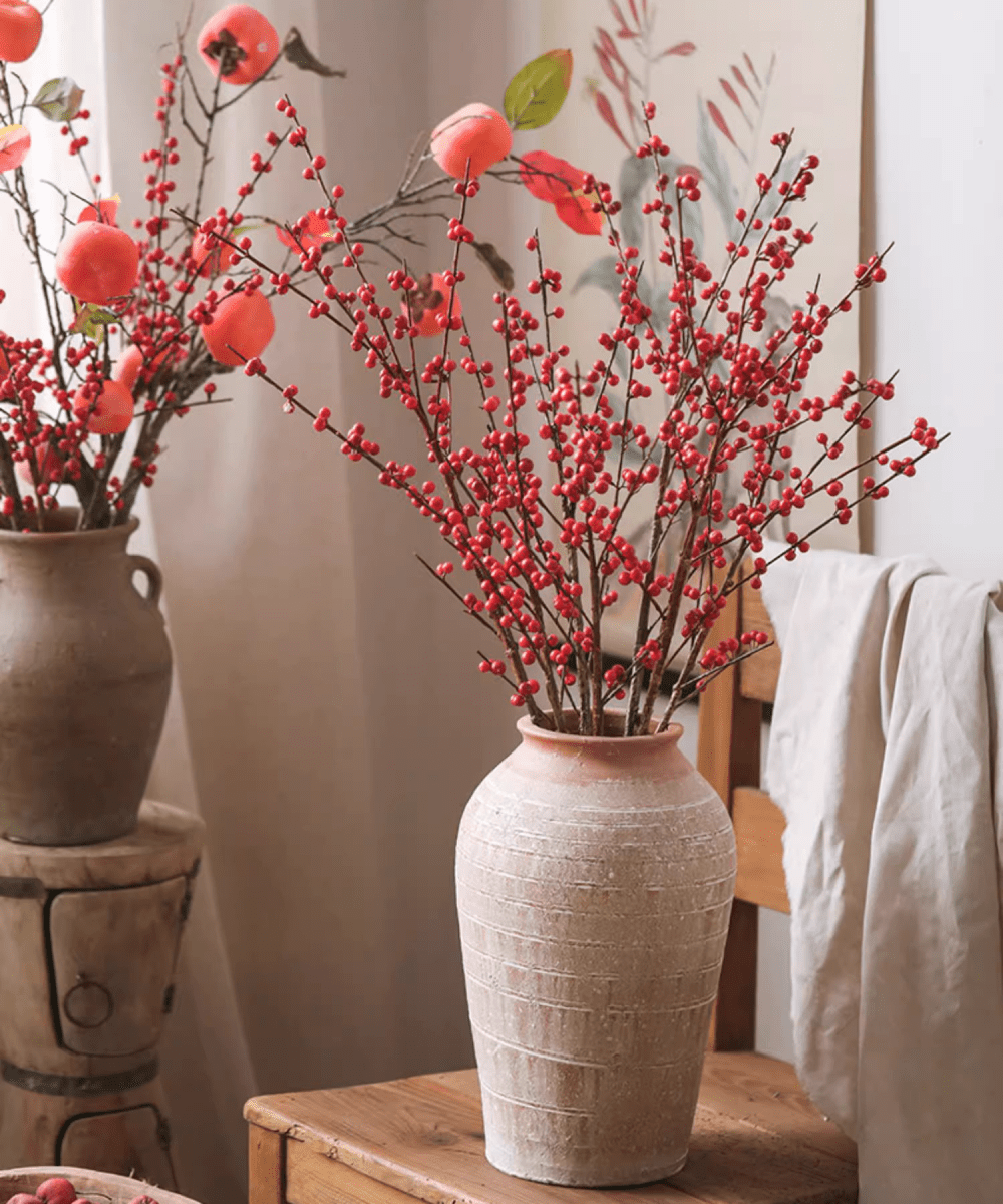 Two Faux Red Winterberry Stems by RusticReach in beige ceramic vases with red berry clusters on Tampa Home & Garden Store