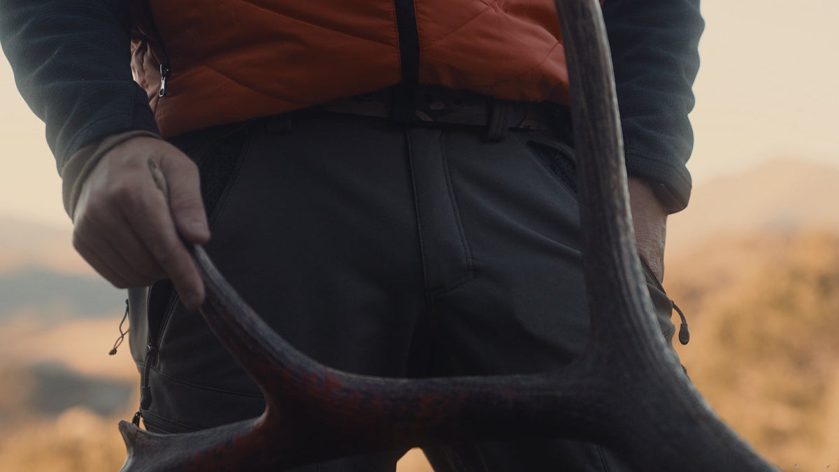 MTN LITE Buckle Ridge Belts on rugged outdoor belt with orange jacket, sunset backdrop on Tampa Home & Garden Store