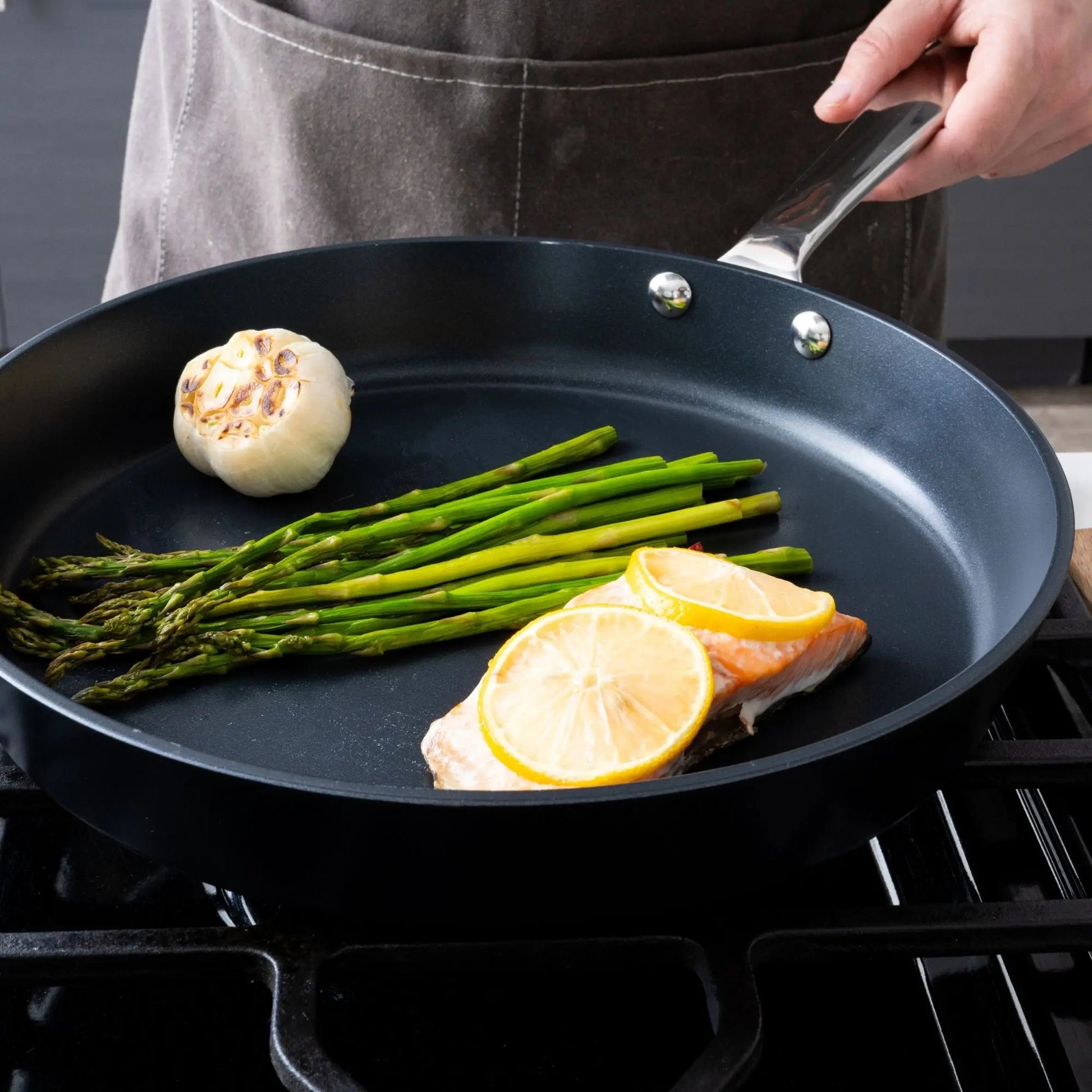 Ceramic nonstick skillet by Alva Cookware with riveted handle cooking asparagus and lemon on Tampa Home & Garden Store