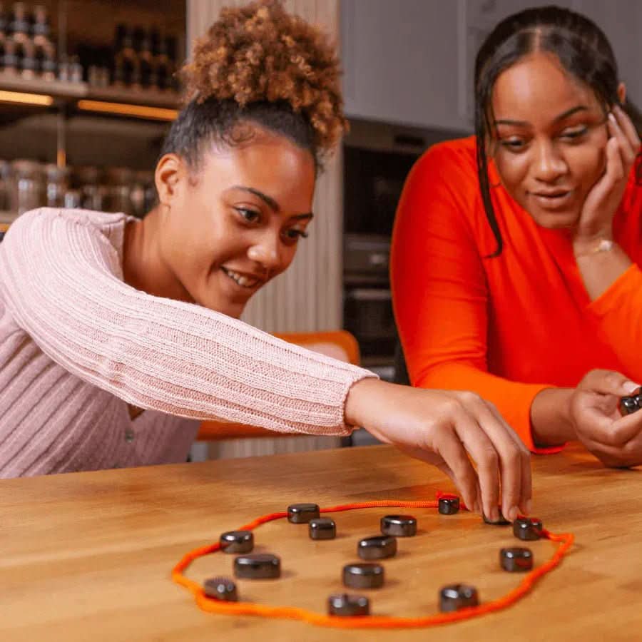 Magnetic Travel Chess Set Moktan Sabai; circular orange cord board with black pieces on Tampa Home & Garden Store