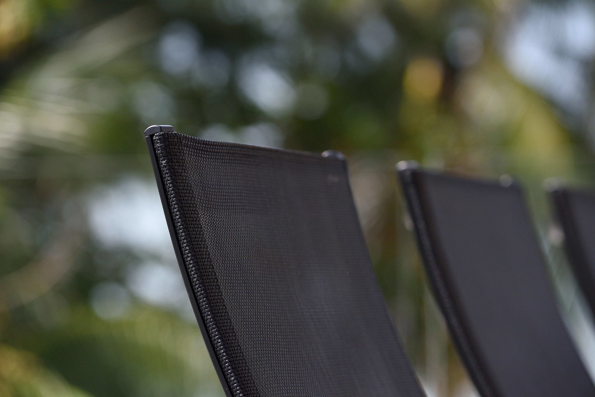 Rinjani Rectangular Table and Manhattan Black Armchair set, close-up of black woven patio chair on Tampa Home & Garden Store