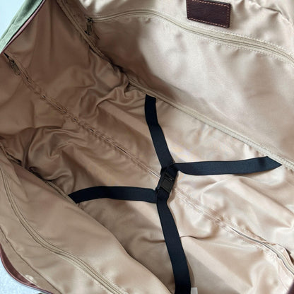 Maxwell waxed canvas rolling duffel bag interior with tan lining, zip pocket, and black straps on Tampa Home & Garden Store