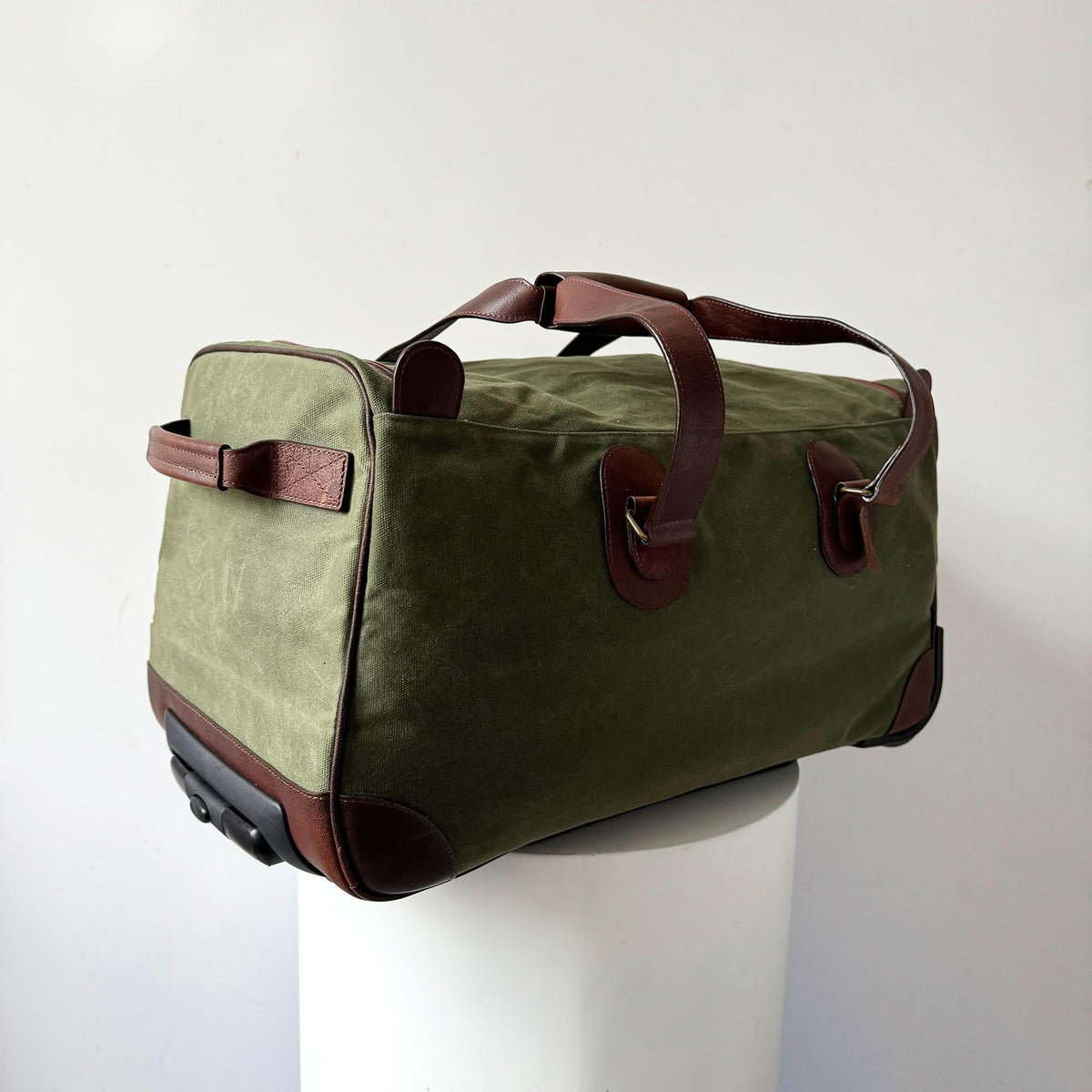 Maxwell waxed canvas rolling duffel bag in olive green with brown leather trim on Tampa Home & Garden Store
